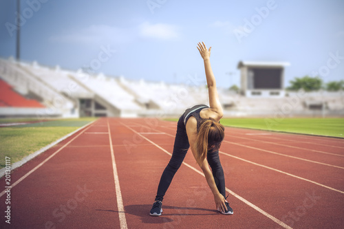 Fitness sport woman stretching herself before running in the morning. 