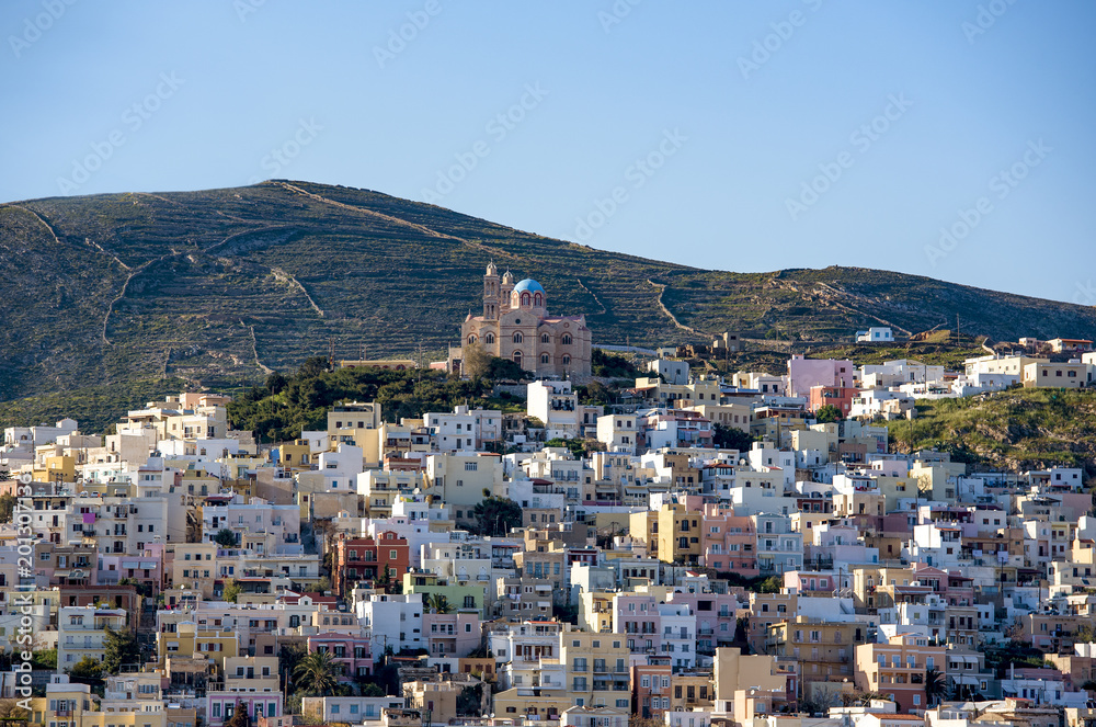Panoramic view of Syros town with the orthodox church on the top the hill. Cyclades islands, Greece