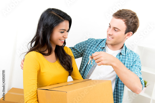 Young interracial couple just moving into new house