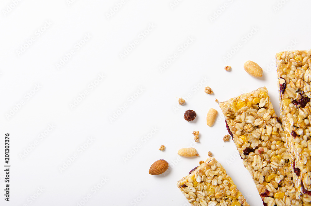 custom made wallpaper toronto digitalEnergy bar of muesli with nuts, berries and oat flakes on a white background. Healthy food, granola for breakfast. Top view.