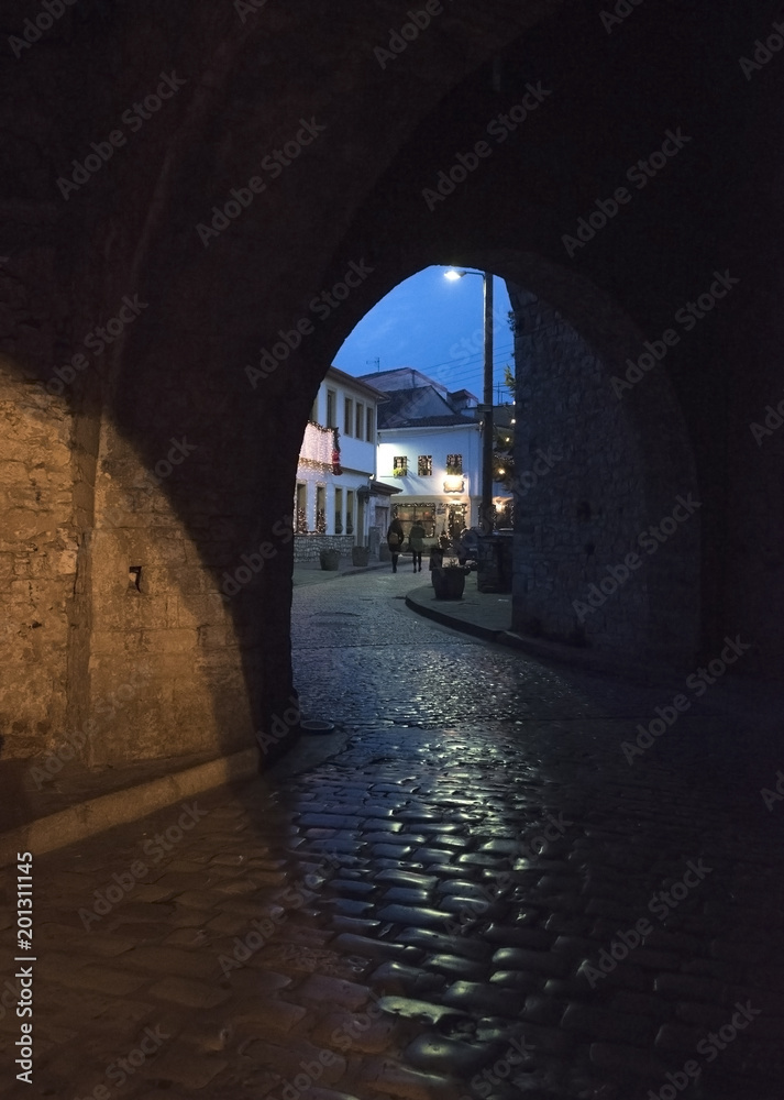 Arch entrance with stone walls to the old city of  Ioannina at night, Greece