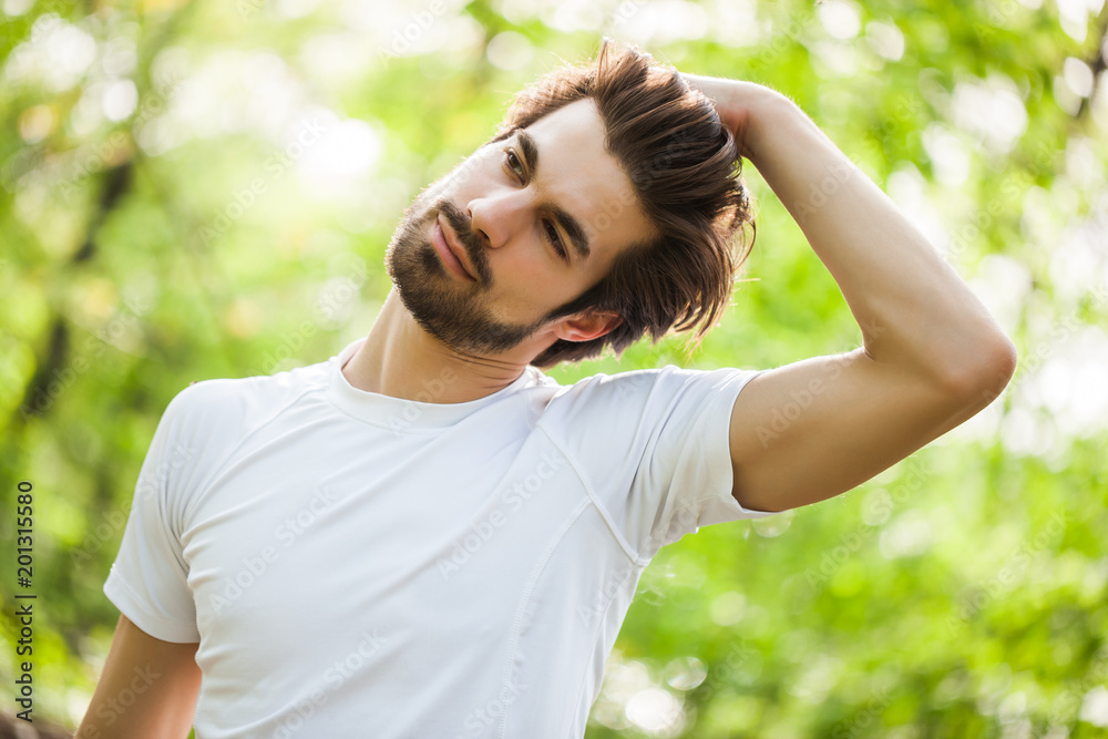 Young man is exercising. He is stretching his body. Young man is exercising. He is stretching his body.