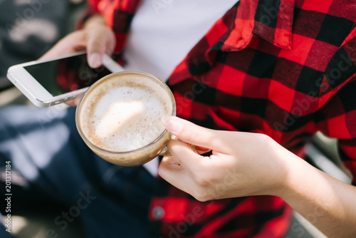 Closeup of female hands holding coffee