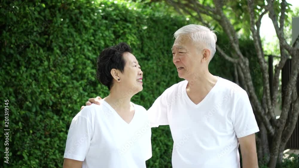 Happy Asian senior couple green bush nature background 4k Happy Asian senior couple green bush nature background 4k
