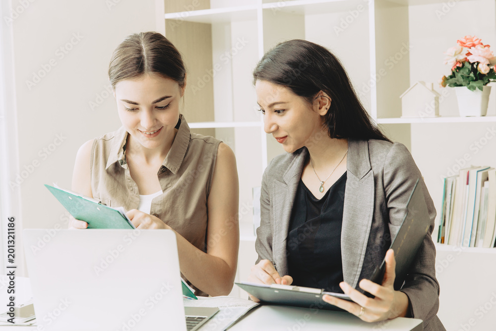 Two Businesswoman team worker co-working together mix race in the office Two Businesswoman team worker co-working together mix race in the office