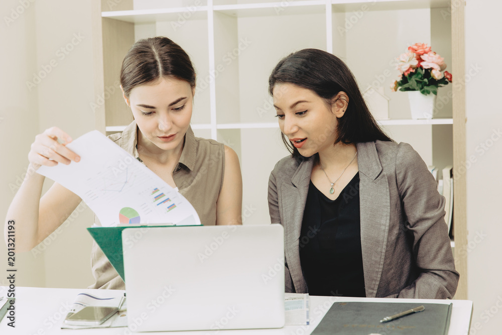 Two Businesswoman team worker co-working together mix race in the office Two Businesswoman team worker co-working together mix race in the office