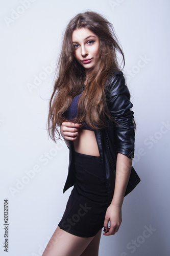Beautiful girl in studio with brown long hair