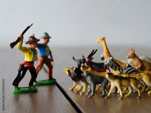 Fototapeta Naklejka Na Ścianę i Meble -  Hunters against wild animals. Miniature plastic figures. Soft focus effect.