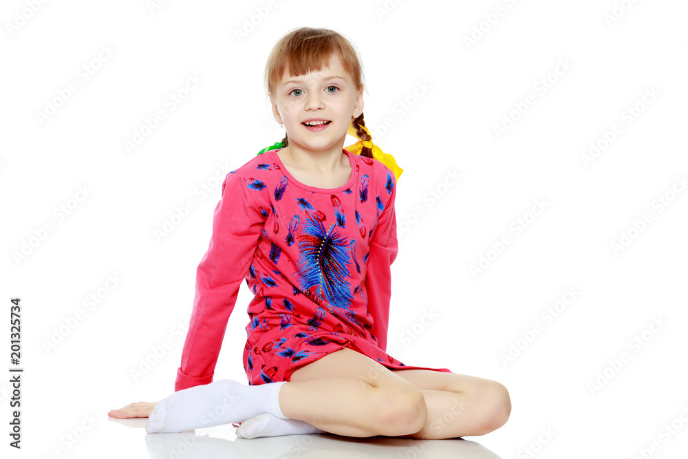 girl sits on the floor and looks directly at the camera. girl sits on the floor and looks directly at the camera.