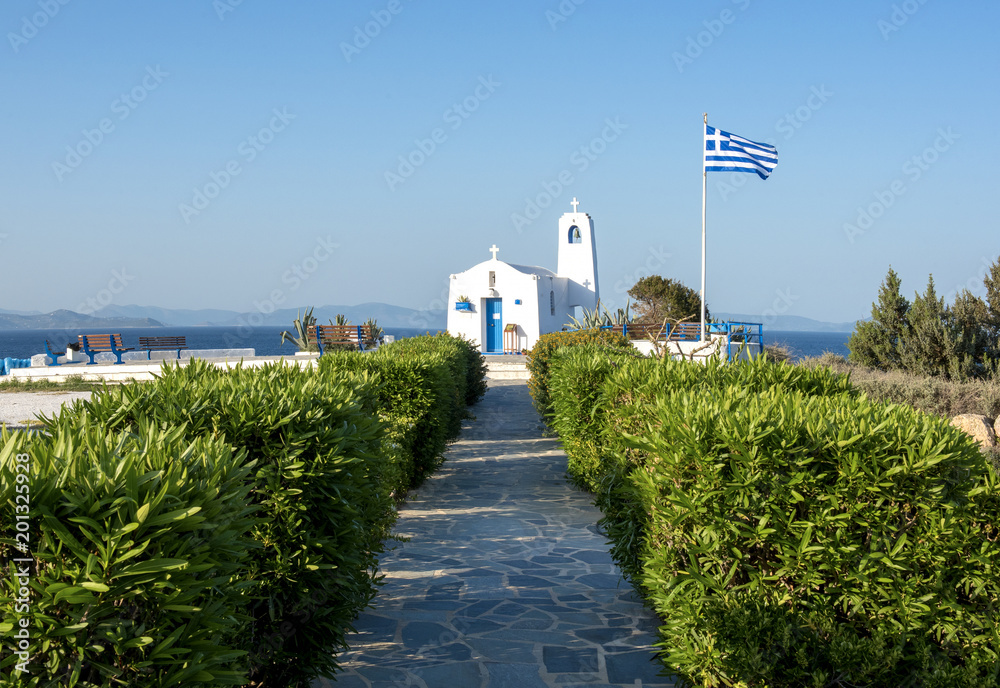 Obraz premium Typical greek place with a white small orthodox chapel dedicated to St Nikolaos. Rafina, Greece