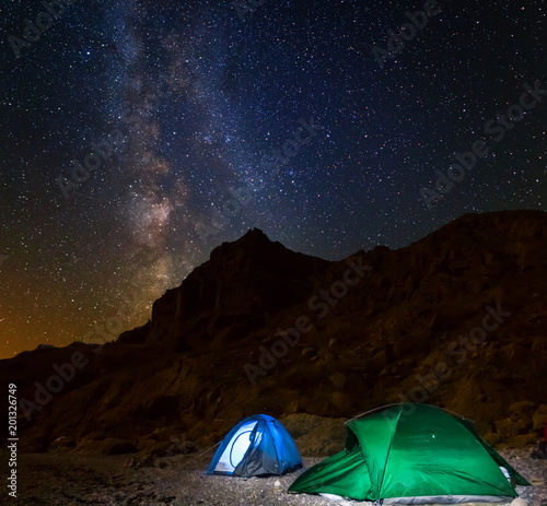 night touristic camp among a mountain under a night starry sky