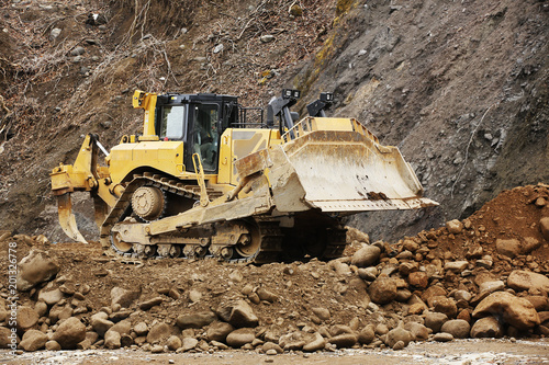 Large bulldozer with the long claw-like device on the back