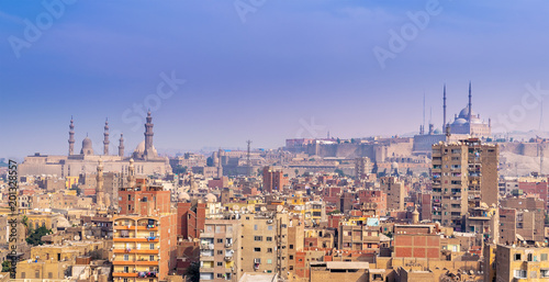 Aerial cityscape view of old Cairo, Egypt with Cairo Citadel and Sultan Hasan Mosque in far distance