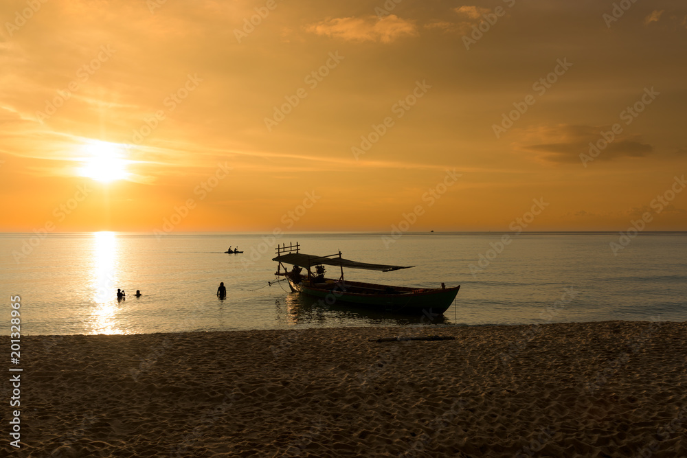 Beautiful Sunset at Sunset Beach with ship and tourist swimming in the sea. Koh Rong Samloem, Cambodia. 
