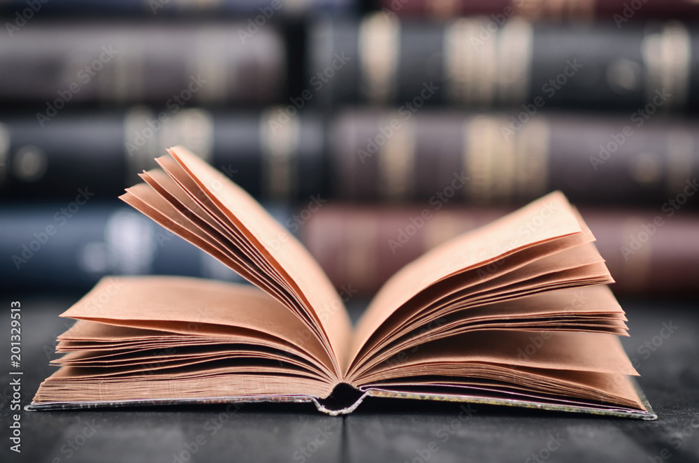 Obraz premium Old empty notebook on the black wooden background.