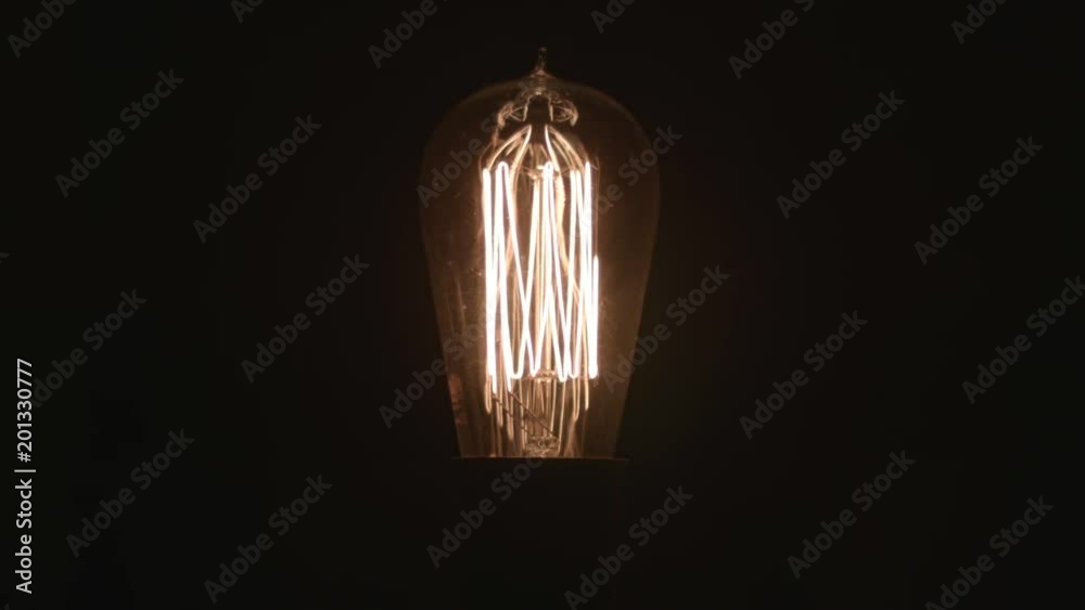 Old fashioned light bulb switches on