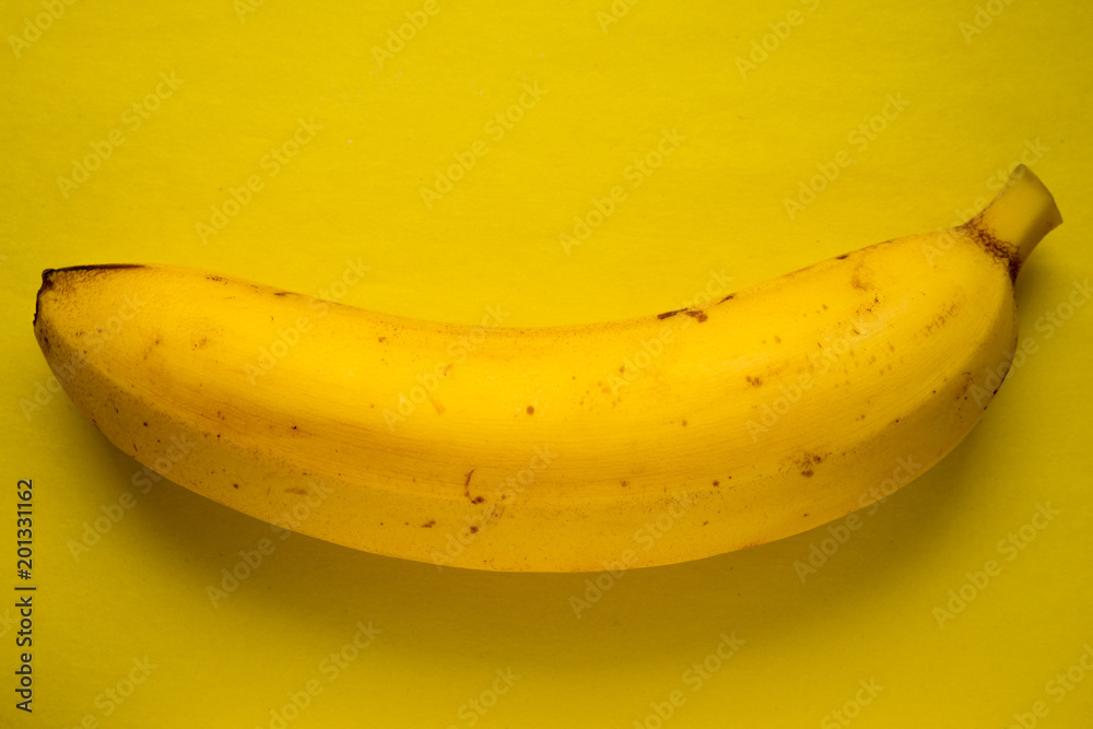 yellow banana on a yellow paper background