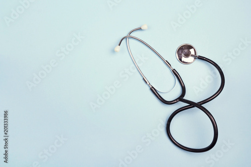 Top view of stethoscope on blue background. Flat lay and copy space.