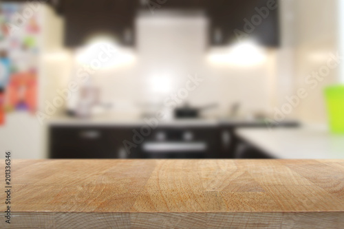 Wooden top table with blurred kitchen interior background