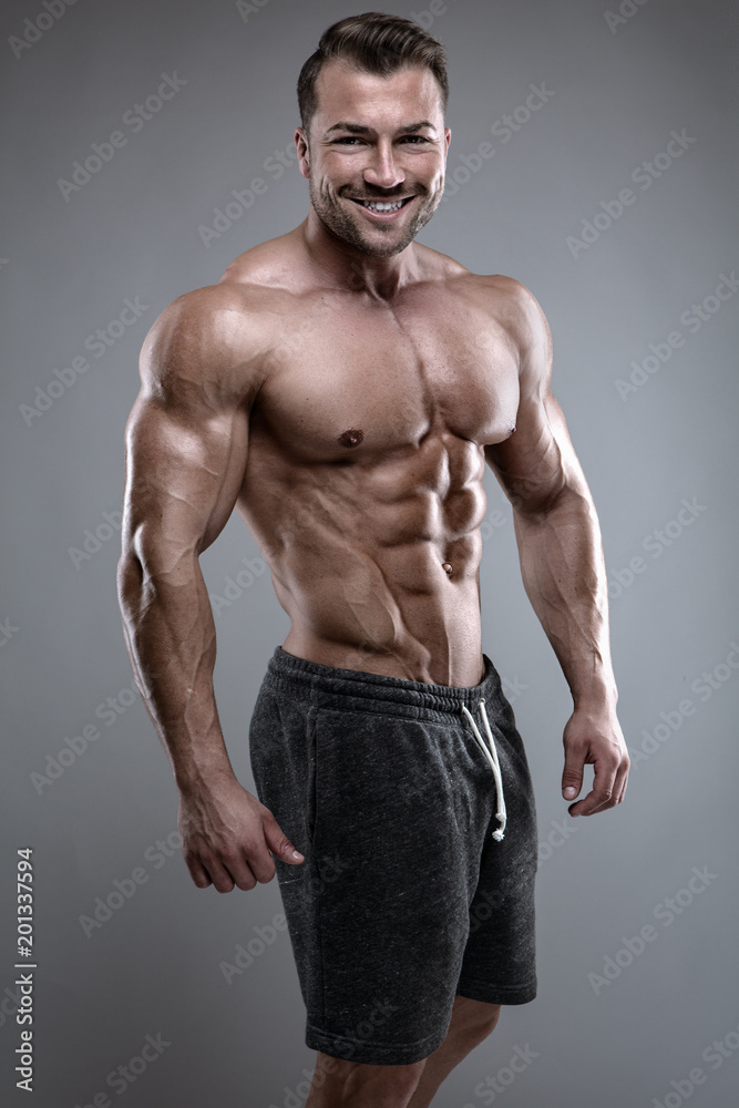 Strong Athletic Man shows body and abdominal muscles