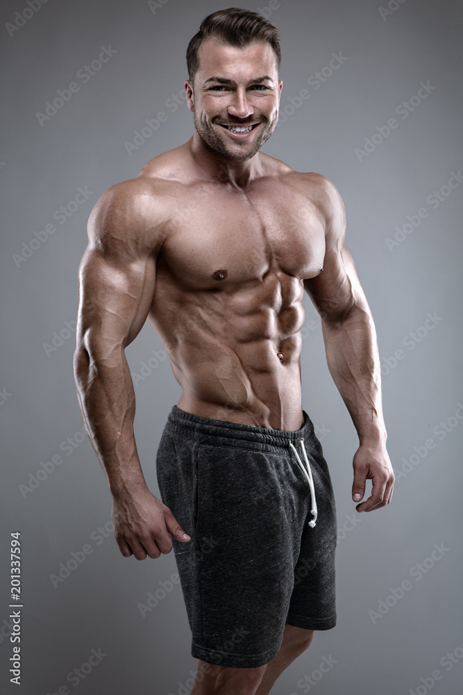 Strong Athletic Man shows body and abdominal muscles Strong Athletic Man shows body and abdominal muscles