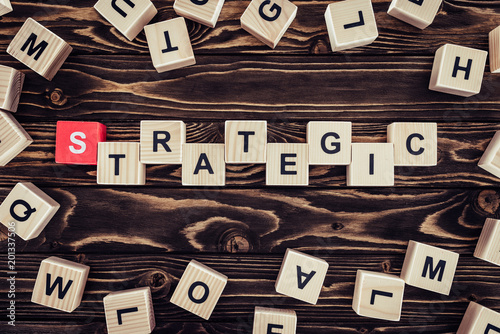 top view of strategy inscription made of wooden blocks on brown wooden surface