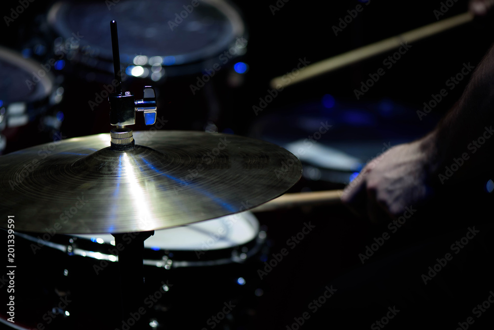 Obraz premium The drummer in action. A photo close up process play on a musical instrument
