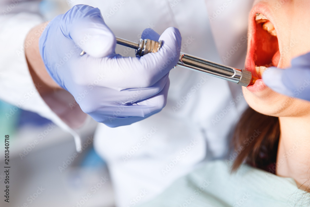 Dentist in gloves puts an anesthetic with syringe to remove tooth in clinic. concept of phobia of doctors, blood Dentist in gloves puts an anesthetic with syringe to remove tooth in clinic. concept of phobia of doctors, blood