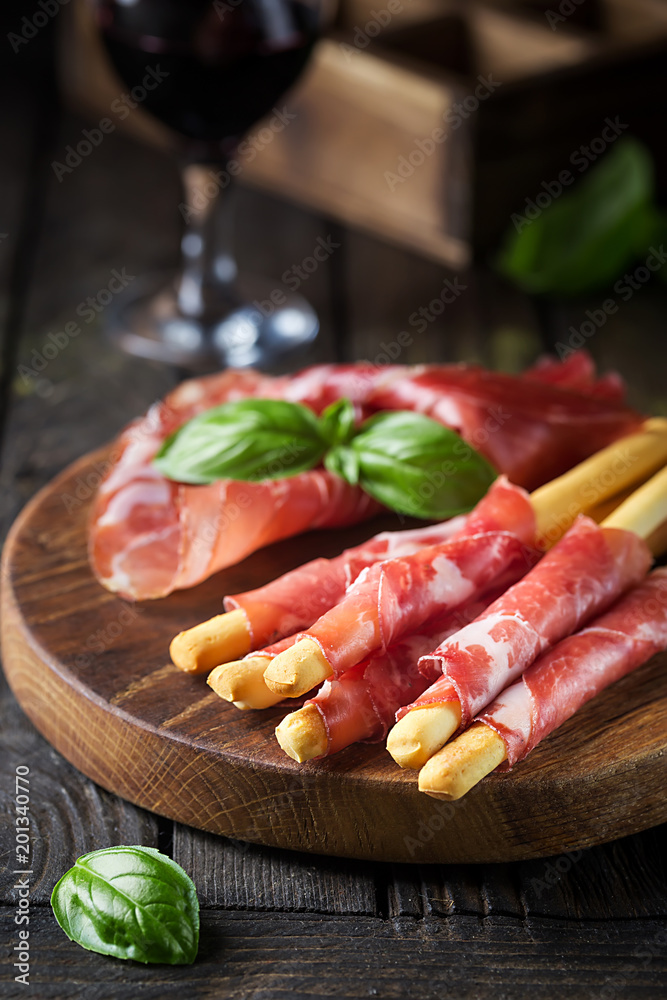 Bread sticks grissini with prosciutto Bread sticks grissini with prosciutto