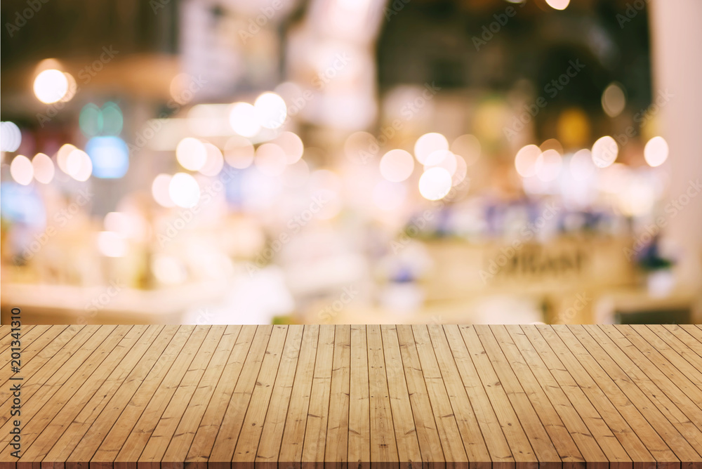 image of wooden table in front of abstract blurred background of resturant lights image of wooden table in front of abstract blurred background of resturant lights