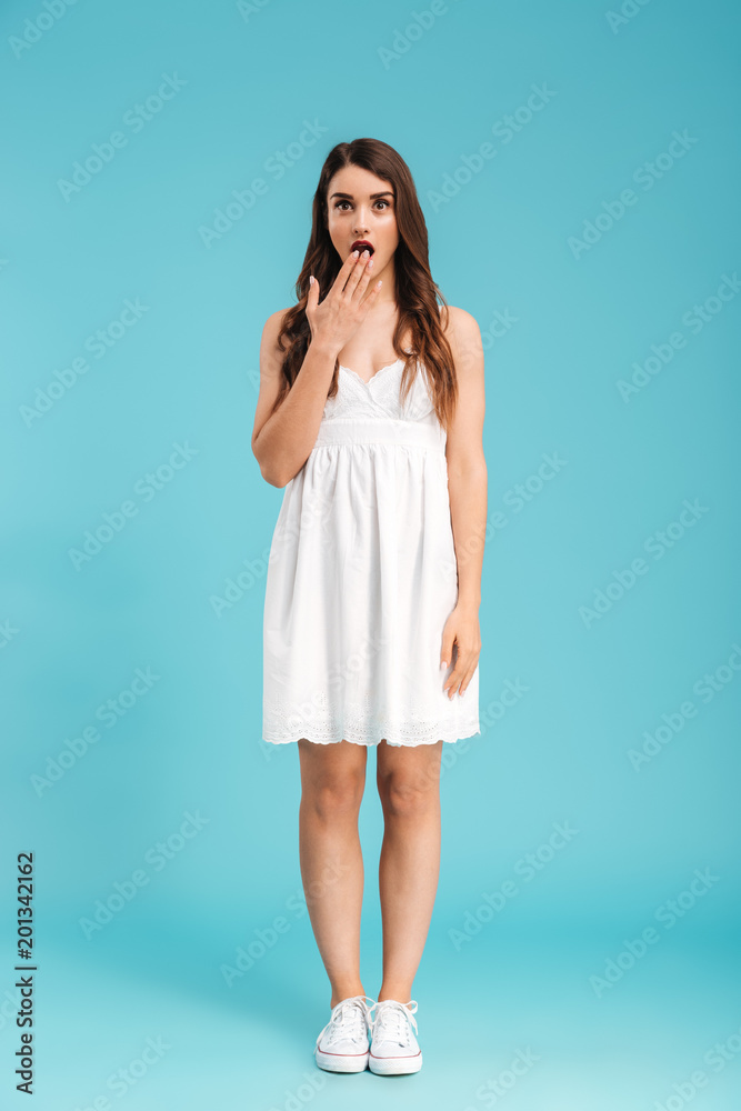 Full length portrait of a shocked young girl