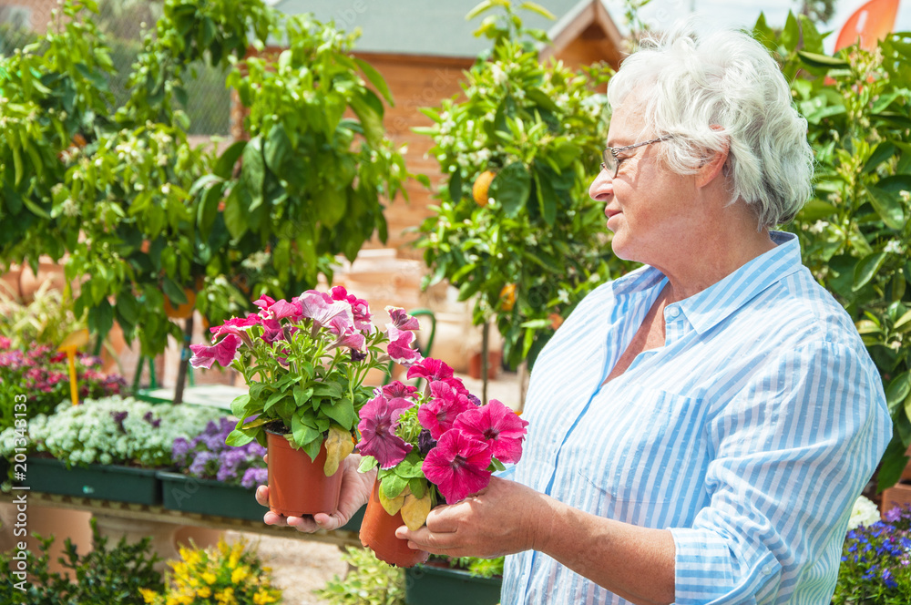  Woman pick out  potted flowers at garden center