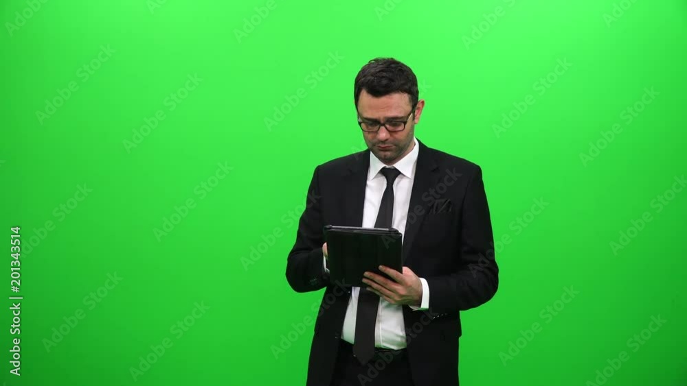 Young Male Businessman Using Tablet with Green Screen Young Male Businessman Using Tablet with Green Screen
