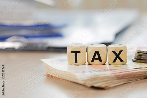 Word Tax composed of wooden letters.  Closeup photo