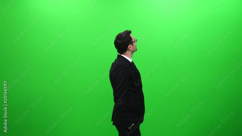 Businessman Looking Around Against A Green Screen Businessman Looking Around Against A Green Screen