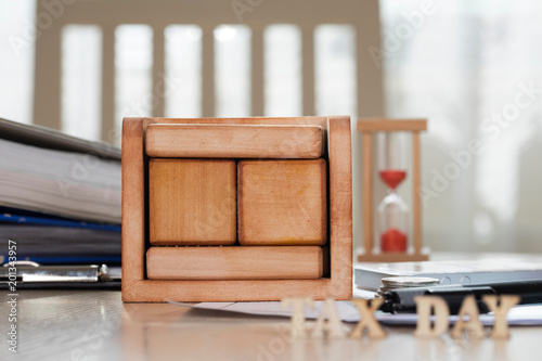 Wooden calendar behind composed letters TAX DAY. photo