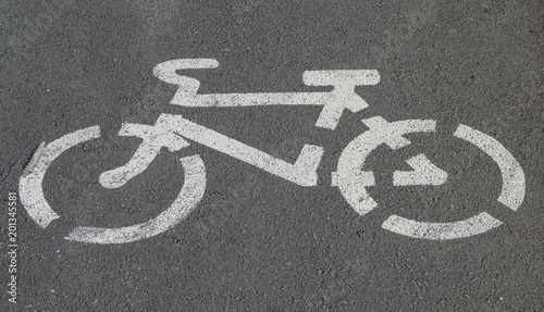  white bicycle sign on the asphalt