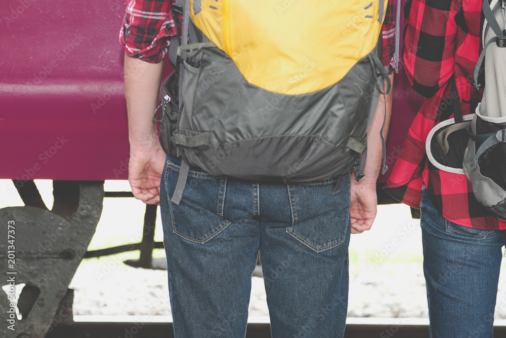 man & woman with backpack waiting for train at railway station. loving couple traveler travel together on holiday man & woman with backpack waiting for train at railway station. loving couple traveler travel together on holiday
