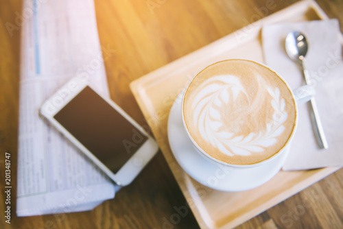 cup of coffee tablet and smart phone on wooden table