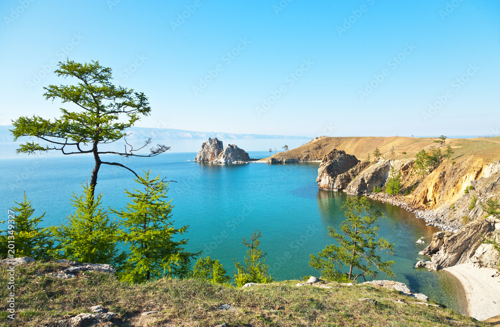 Lake Baikal. Beautiful summer landscape of the Olkhon Island. The famous Shamanka Rock, Tataiskiy Cape and the beach of the Khuzhirskiy Bay on a sunny June day