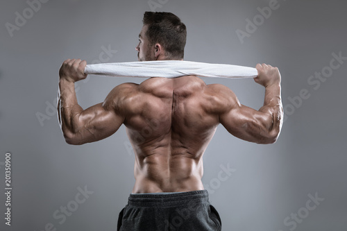 Strong Athletic Man Fitness Model posing back muscles, triceps, latissimus photo