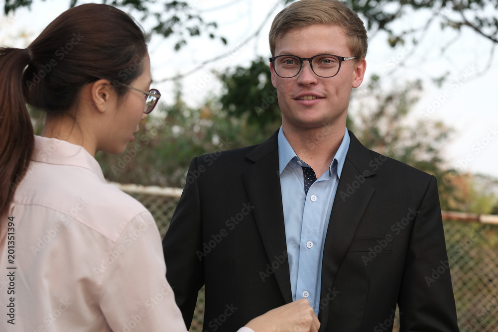 woman arrange businessman shirt and suit outdoor. girlfriend adjust boyfriend clothes. woman arrange businessman shirt and suit outdoor. girlfriend adjust boyfriend clothes.
