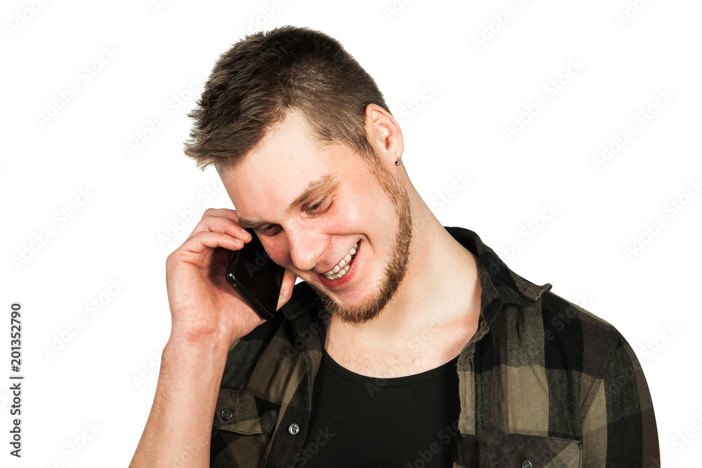 Young smiling guy with beard and modern hairstyle, talking on smartphone, isolated on white background. Young smiling guy with beard and modern hairstyle, talking on smartphone, isolated on white background.