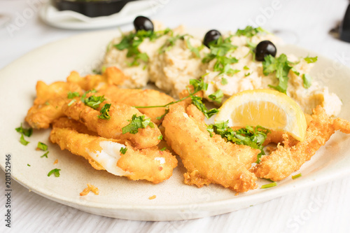 fried squid with lemon on white dish