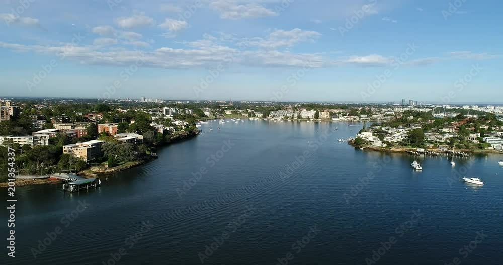 Wide Parramatta river flowing towards Sydney harbour from Western Sydney in inner West on a sunny day with daily river routing – residential houses, marina, yachts.
Wide Parramatta river flowing towards Sydney harbour from Western Sydney in inner West on a sunny day with daily river routing – residential houses, marina, yachts.