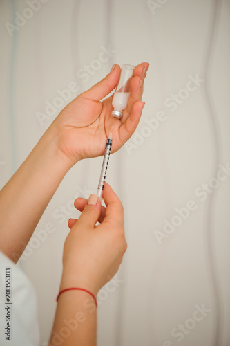 Girl picking up insulin in a syringe close-up. Diabetes.