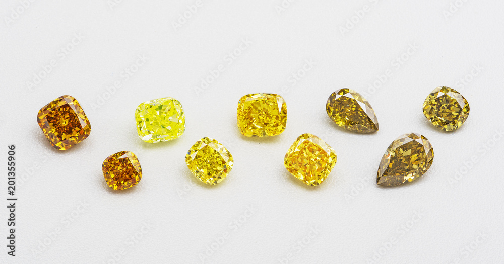 Set of luxury yellow and brown transparent sparkling gemstones of various cut shape diamonds collage on white background Set of luxury yellow and brown transparent sparkling gemstones of various cut shape diamonds collage on white background