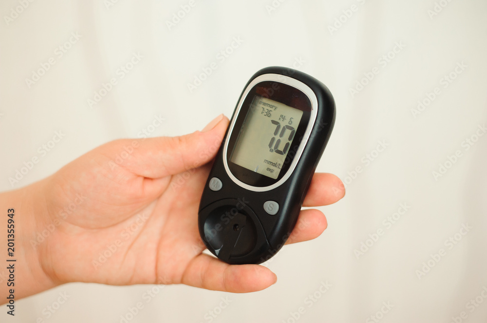glucometer with result of measurement sugar level and tape measure, concept of diabetes glucometer with result of measurement sugar level and tape measure, concept of diabetes