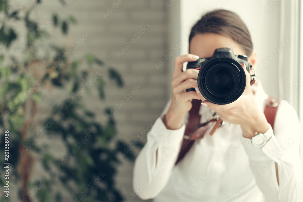 Pretty woman is a professional photographer with dslr camera Pretty woman is a professional photographer with dslr camera