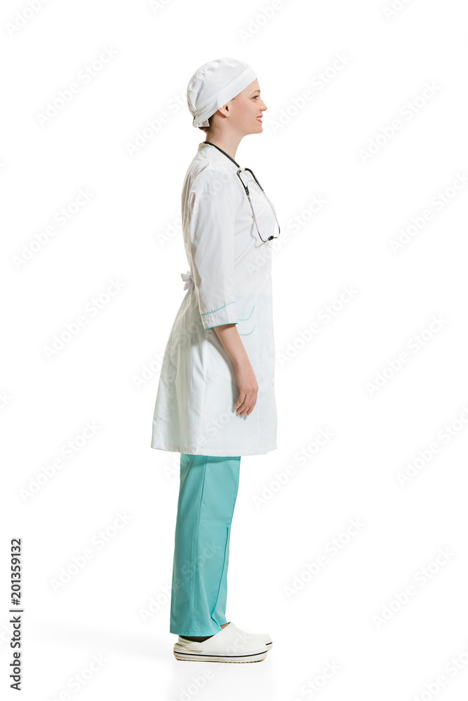 Beautiful young woman in white coat posing at studio. Full length studio shot isolated on white. Beautiful young woman in white coat posing at studio. Full length studio shot isolated on white.